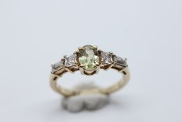 AN ELEGANT MODERN 9CT GOLD STONE SET DRESS RING.