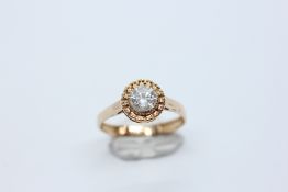 A ROUND BRILLIANT CUT NATURAL DIAMOND RING MARKED 585 14K ALONG WITH A WORLD GEMOLOGICAL INSTITUTE