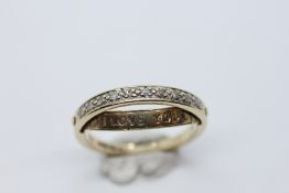 A 9CT GOLD DIAMOND SET HALF ETERNITY RING WITH A CONCEALED SECTION TITLED "I LOVE YOU".