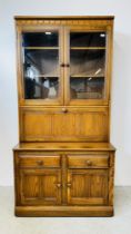 A MODERN ERCOL GOLDEN DAWN DISPLAY CABINET WITH DRAWER AND CABINET BASE W 98CM D 50CM H 197CM.