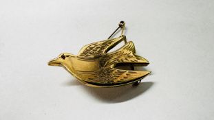 A 9CT GOLD DOVE BROOCH, THE EYE SET WITH SMALL RUBY FITTED WITH SAFETY CHAIN.