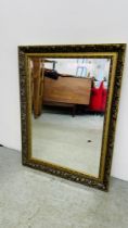 A BEVELLED GLASS GILT FRAMED ORNATE WALL MIRROR. W 62CM X H 83CM.