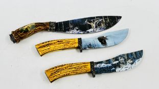 A GROUP OF THREE DECORATIVE KNIVES WITH HORN STYLE HANDLES THE BLADES DEPICTING WAVES AND EAGLES -