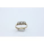 A 9CT GOLD THREE STONE DIAMOND RING.