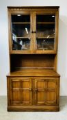 A MODERN ERCOL GOLDEN DAWN DISPLAY CABINET WITH CABINET BASE W 98CM D 50CM H 197CM.