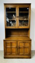 A MODERN ERCOL GOLDEN DAWN DISPLAY CABINET WITH CABINET BASE W 98CM D 50CM H 197CM.
