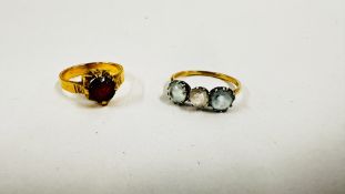 TWO VINTAGE YELLOW METAL STONE SET RINGS TO INCLUDE A THREE STONE EXAMPLE.