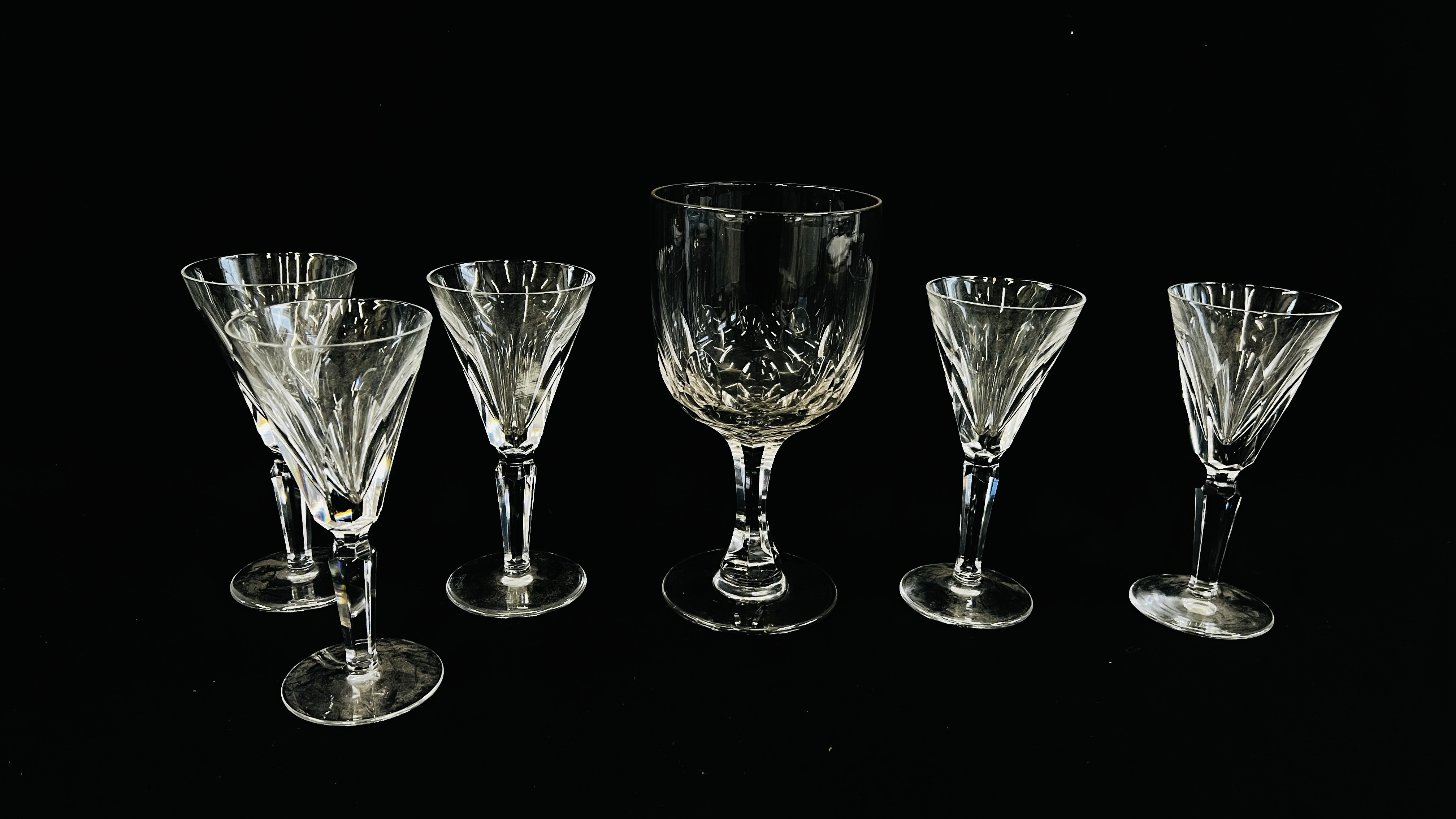 A TALL RUMMER ON A HEXAGONAL STEM AND CIRCULAR FOOT ALONG WITH 5 WATERFORD SHERRY GLASSES,