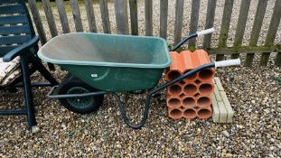 A GARDEN WHEELBARROW AND 4 SECTIONS OF TERRACOTTA PIPES.