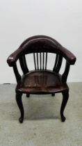 A HARDWOOD ELBOW CHAIR WITH LEATHERED ARMS AND BACK REST.