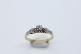 A SMALL DIAMOND SOLITAIRE RING MARKED 18CT AND PLAT.
