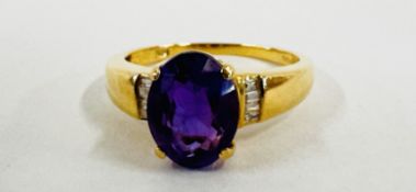 A 14K GOLD RING SET WITH A CENTRAL OVAL AMETHYST AND INSET DIAMONDS TO THE SHOULDERS.