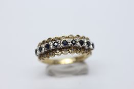 AN ELEGANT 9CT GOLD DIAMOND AND SAPPHIRE RING IN A CHANNEL SETTING.