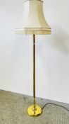A REPRODUCTION BRASS FINISH COLUMNED STANDARD LAMP WITH SHADE - SOLD AS SEEN.