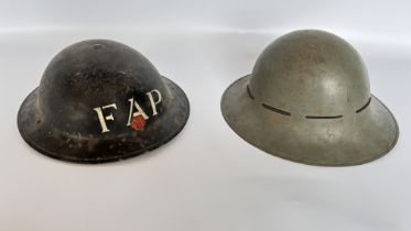 2 WWII TIN HELMETS, 1 FAP, 1 GREY - A/F CONDITION, SOLD AS SEEN.