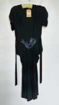 1940S BLACK CREPE COCKTAIL DRESS, SILVER/BLUE BEAD DECORATION ON WAISTLINE, SHORT SLEEVES,