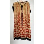 1920S MUSLIN BEIGE DROP WAISTED DRESS WITH RED SPOTS, BLACK TRIM TO SLEEVES,