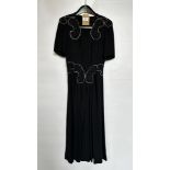 1940S BLACK CREPE CLASSIC STYLE COCKTAIL DRESS WITH BLUE AND SILVER BEADING TO SHOULDER AND