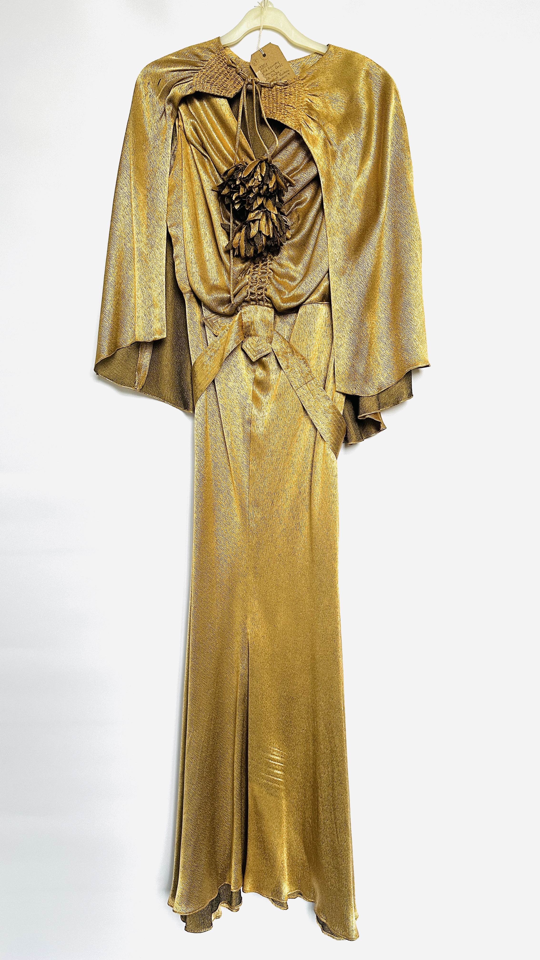 1930S GOLD LAMÉ EVENING DRESS WITH CAPE, RUCHED BODICE WITH FLOWERS AND BELT - A/F CONDITION,