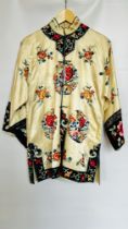 1920S CREAM SATIN CHINESE PYJAMAS, HEAVILY EMBROIDERED WITH FLOWERS, BLACK EMBROIDERED AT NECKLINE,
