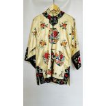 1920S CREAM SATIN CHINESE PYJAMAS, HEAVILY EMBROIDERED WITH FLOWERS, BLACK EMBROIDERED AT NECKLINE,