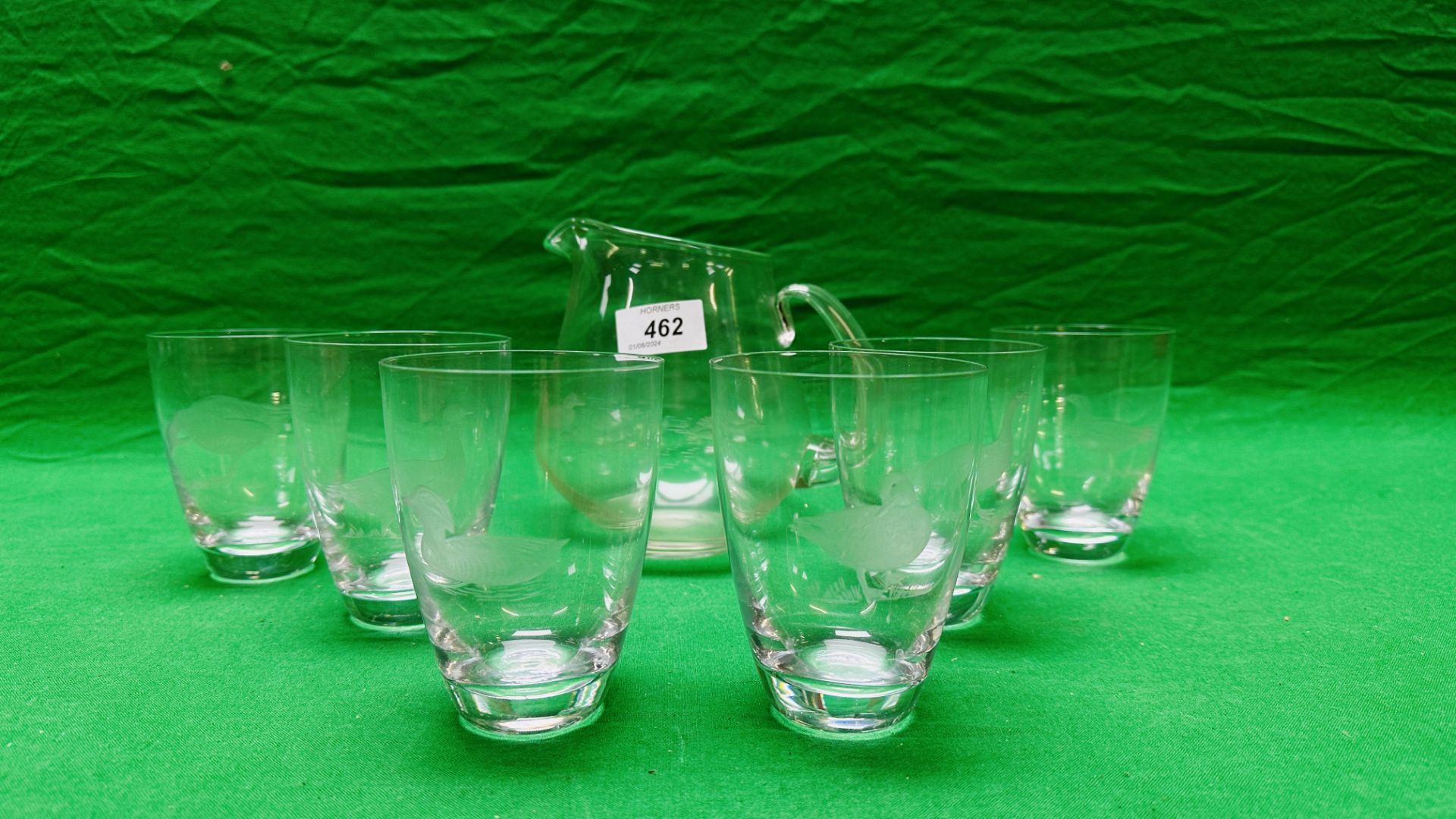 A HAND BLOWN WATER JUG AND SIX SPIRIT TUMBLERS,