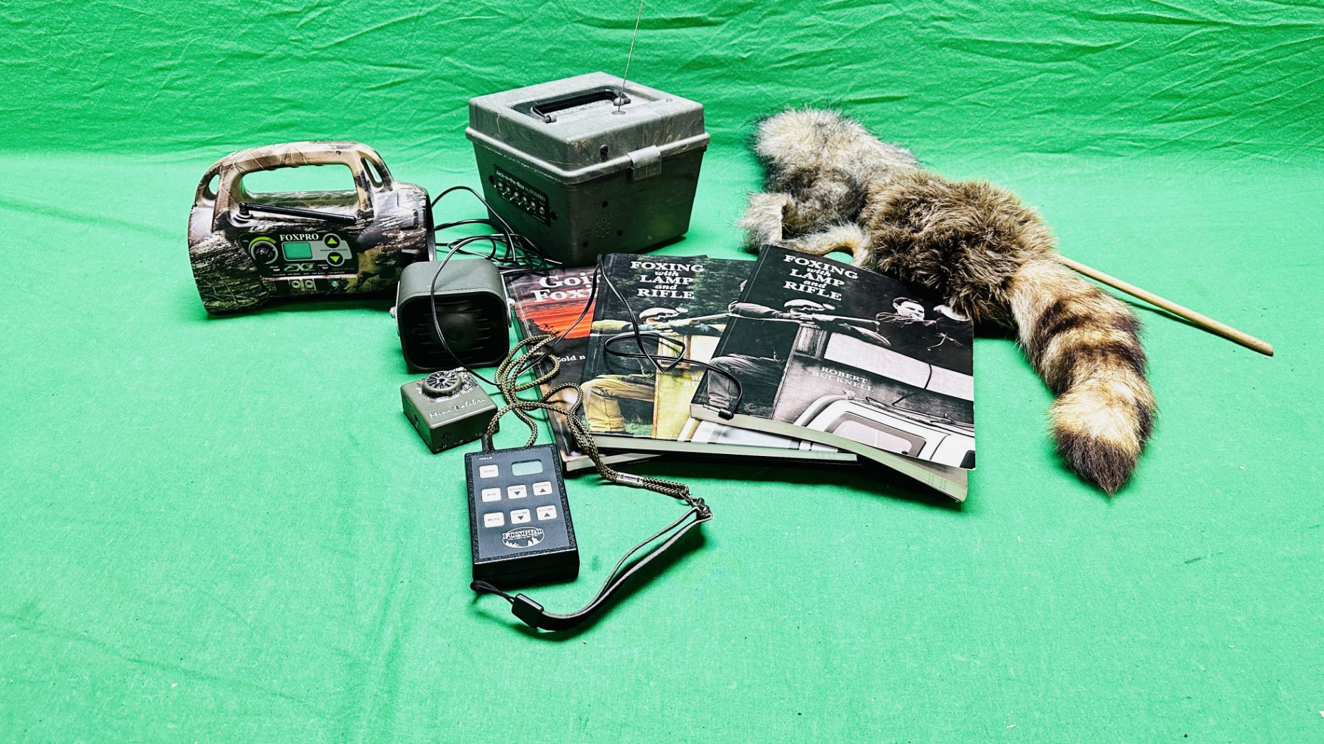 A GROUP OF FOXING RELATED EQUIPMENT AND BOOKS TO INCLUDE FOX PRO FX3, FOX PRO TX5-LR REMOTE,