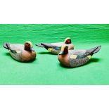 A HANDCRAFTED SET OF THREE DUCK DECOYS HAVING HANDPAINTED DETAIL AND GLASS EYES.
