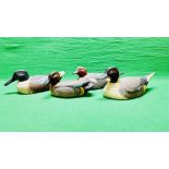 A HANDCRAFTED SET OF 4 DUCK DECOYS HAVING HANDPAINTED DETAIL AND GLASS EYES.