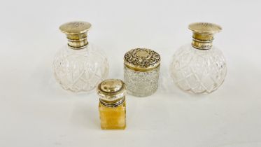 A PAIR OF ANTIQUE GLASS DRESSING TABLE PERFUME DECANTERS WITH SILVER TOPS, BIRMINGHAM ASSAY H 12.