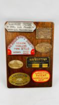 MAHOGANY BOARD CONTAINING 8 VINTAGE CAST AND BRASS PLAQUES INCLUDING GARRETTS PATENT, J.