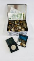 A TIN OF ASSORTED COINAGE AND BANK NOTES.