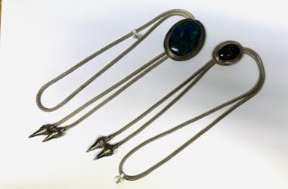TWO DESIGNER SILVER INDONESIAN WOVEN BOLO TIES.