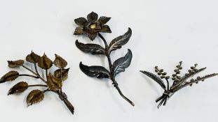 A GROUP OF THREE VINTAGE SILVER BROOCHES TO INCLUDE AN EXAMPLE OF A FLOWER AND A SPRIG OF LEAVES.