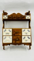 A VINTAGE WAXED PINE WALL MOUNTED MULTI DRAWER STORAGE CABINET WITH 6 CERAMIC DRAWERS H 72 X W 50,