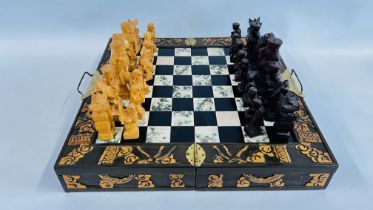 A VINTAGE STYLE CHINESE FOLDING CHESS BOARD WITH HAND CARVED PIECES.
