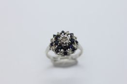 A 9CT WHITE GOLD SAPPHIRE AND DIAMOND RING.
