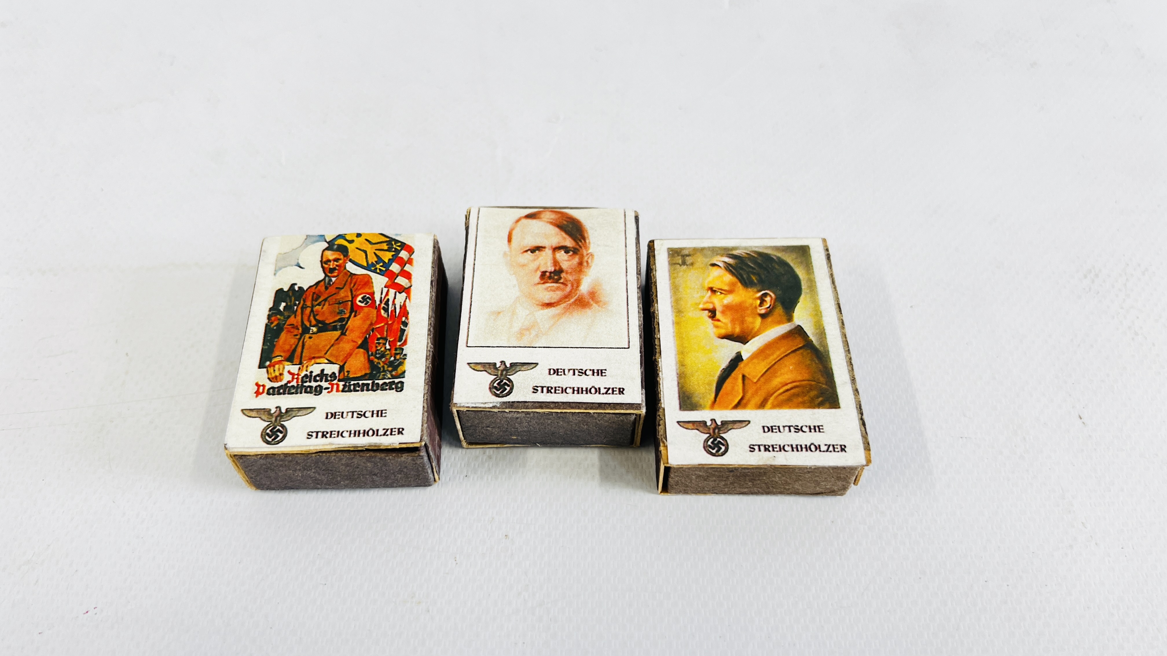 A GROUP THREE MATCHBOXES DEPICTING AN IMAGE OF "HITLER".