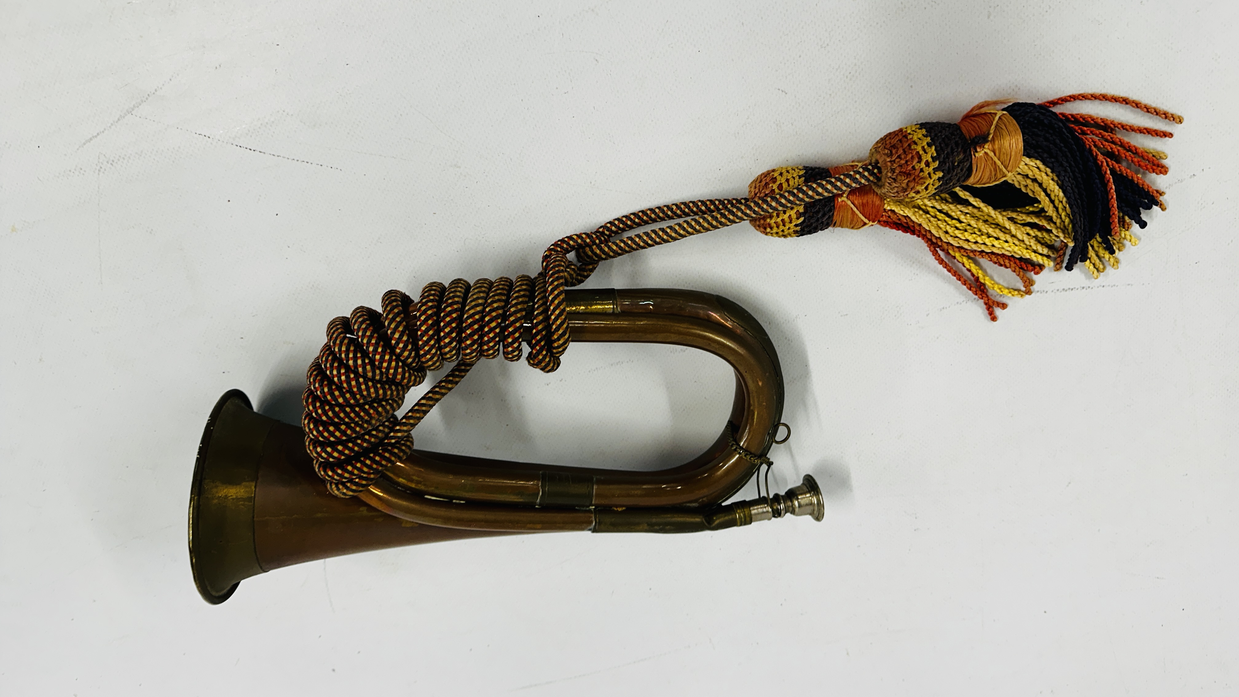 VINTAGE MILITARY COPPER + BRASS BUGLE WITH REGIMENTAL COLOURS.