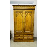 A SOLID PINE ANTIQUE FINISH DOUBLE WARDROBE WITH FOUR DRAWERS TO BASE, W 130CM X D 60CM X H 217CM.