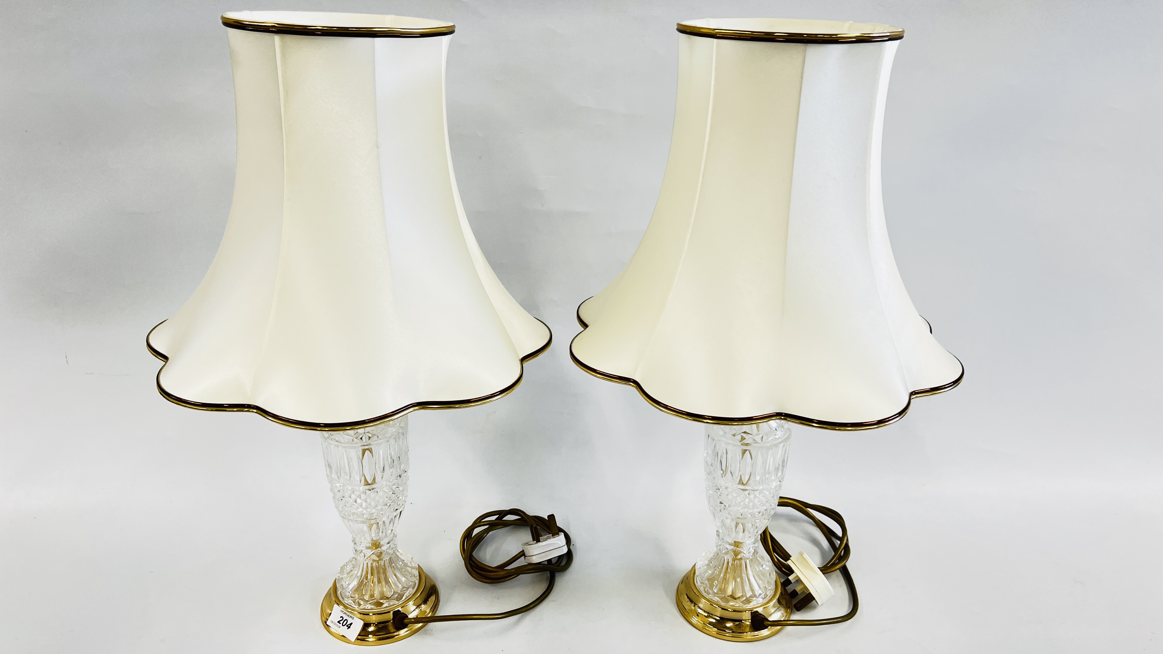 PAIR OF LEAD CRYSTAL TABLE LAMPS WITH CREAM SHADES, OVERALL HEIGHT 58CM - SOLD AS SEEN.