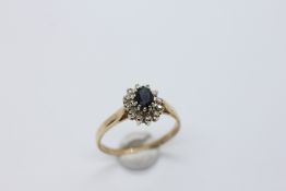 A 9CT GOLD DIAMOND AND SAPPHIRE CLUSTER RING.