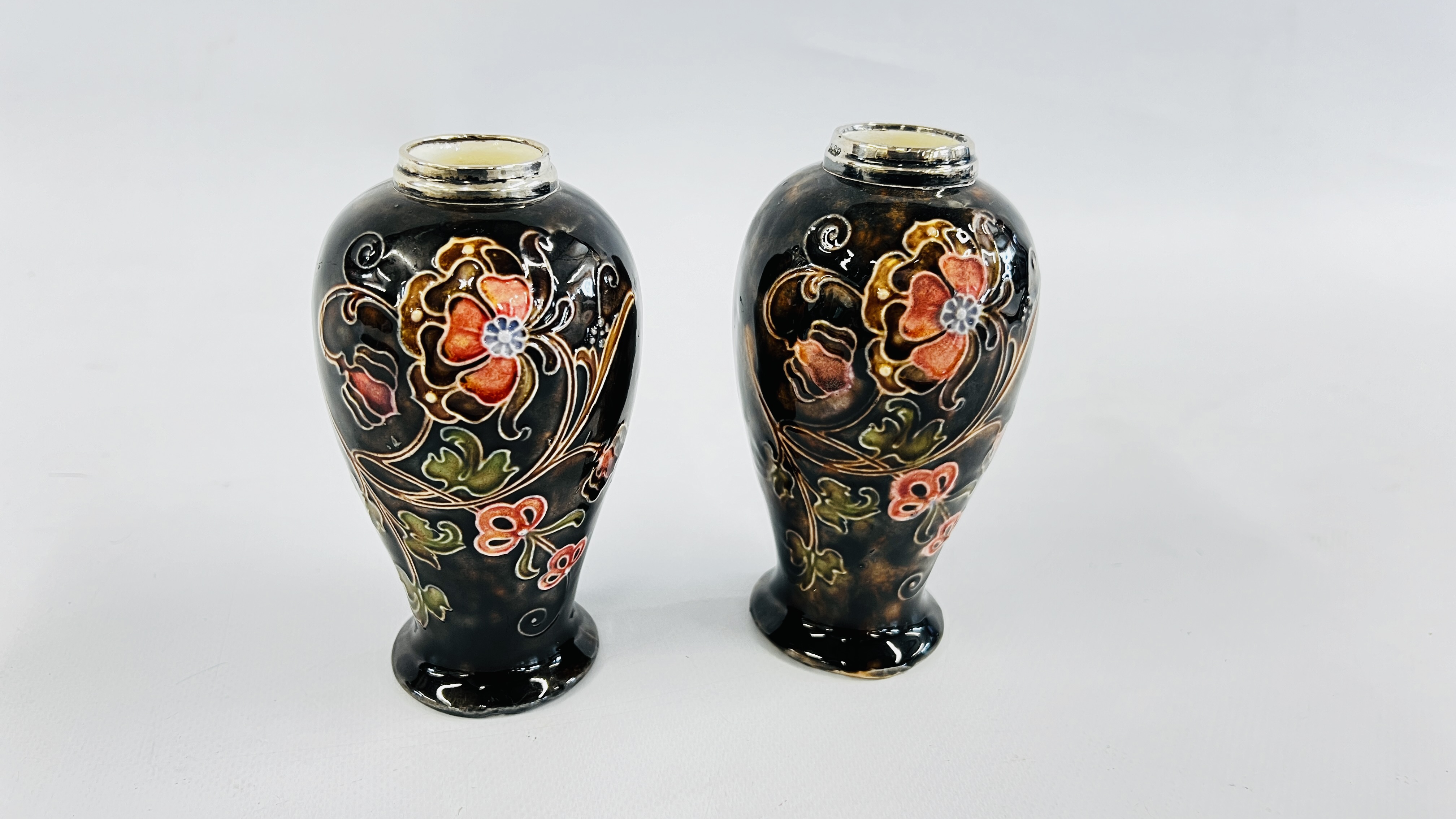 A PAIR OF VINTAGE SILVER RIMMED GLAZED VASES IN THE MOORCROFT STYLE,