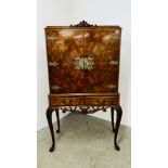 A CONTINENTAL STYLE REPRODUCTION WALNUT FINISH DRINKS CABINET WITH ORNATE BRASS EMBELLISHMENTS,