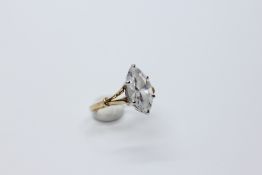 A 9CT GOLD SOLITAIRE SET WITH MARQUISE CLEAR CUT GLASS.