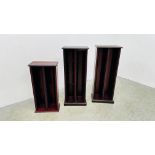 A PAIR OF MAHOGANY FINISH CD RACKS EACH W 35 CM X D 24CM X H 88CM ALONG WITH 1 FURTHER SMALLER W