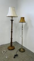 A CARVED PINE LAMP STANDARD AND CREAM SHADE AND A MODERN BRASSED ADJUSTABLE LAMP STANDARD AND