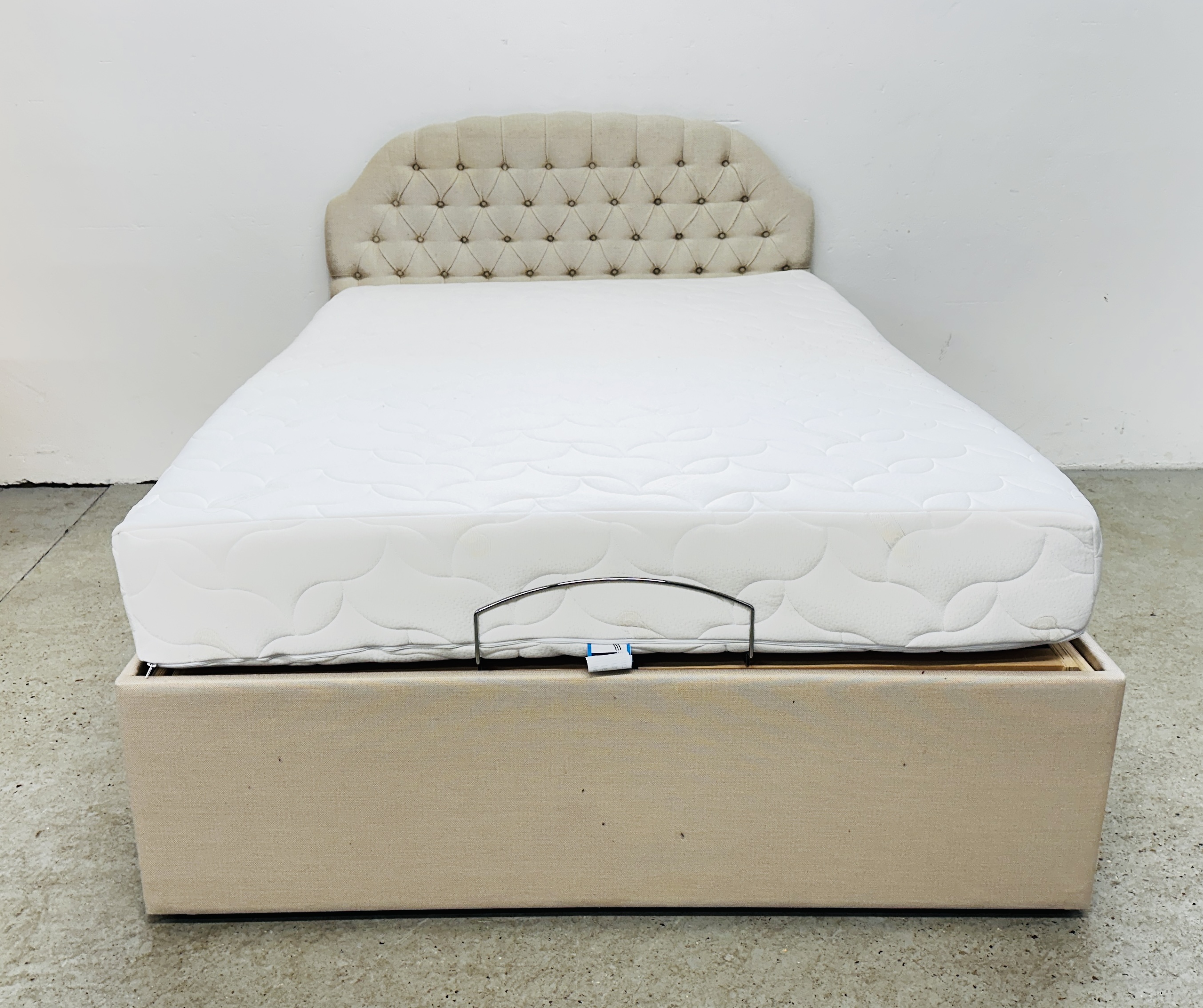 AN ELECTRICALLY ADJUSTABLE DOUBLE BED WITH COOLMAX MATTRESS AND OATMEAL UPHOLSTERED STEWART JONES