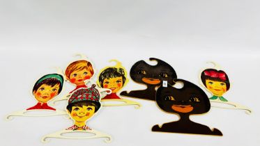 FIVE STREPP DESIGN RETRO CHILDRENS COAT HANGERS ALONG WITH TWO OTHERS.