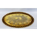 AN IMPRESSIVE LARGE OVAL BRASS TRAY ENGRAVED WITH EASTERN ELEPHANTS AND FOLIAGE W 92CM X H 57.5CM.